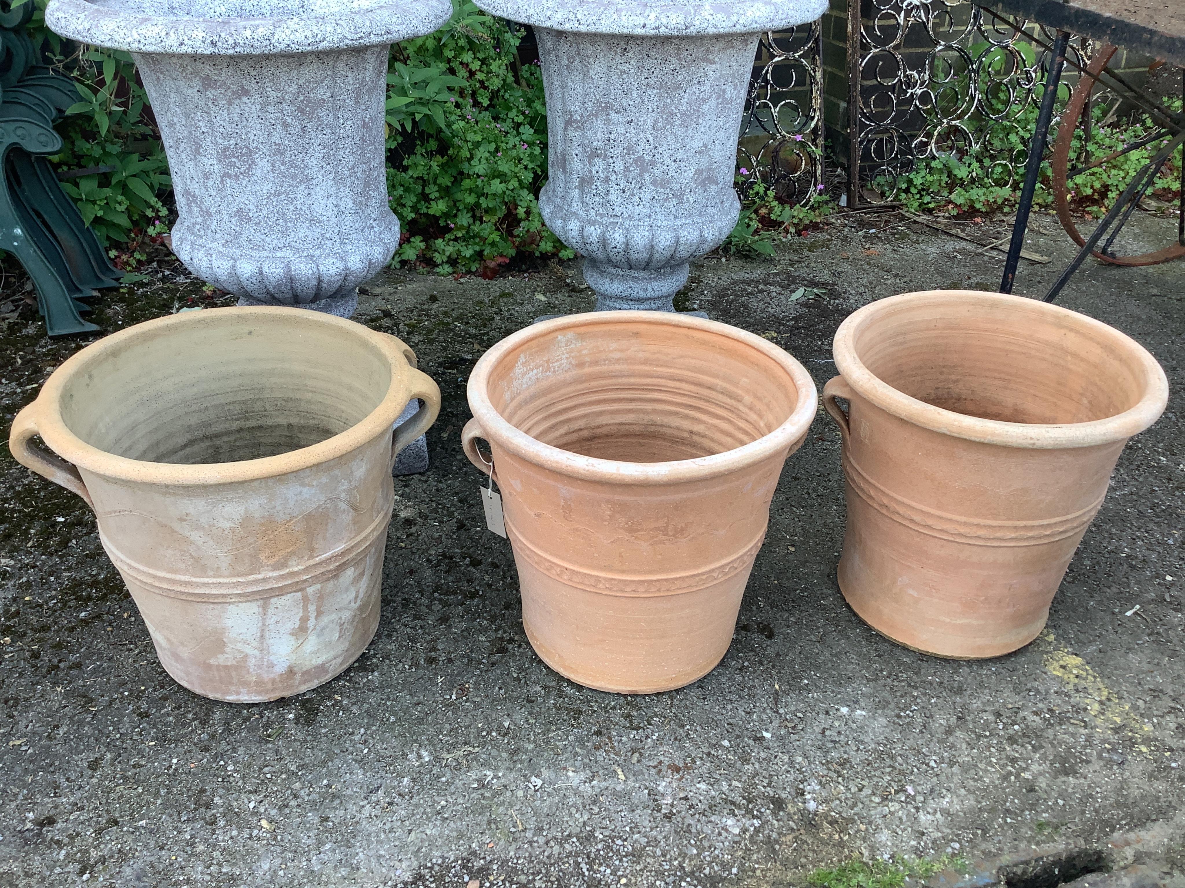 Three circular terracotta garden planters, diameter 41cm, height 38cm